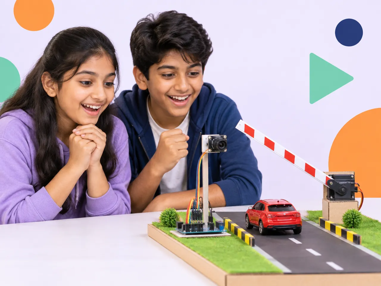 Two children watch their model gate lift open for a toy car spotted by a camera